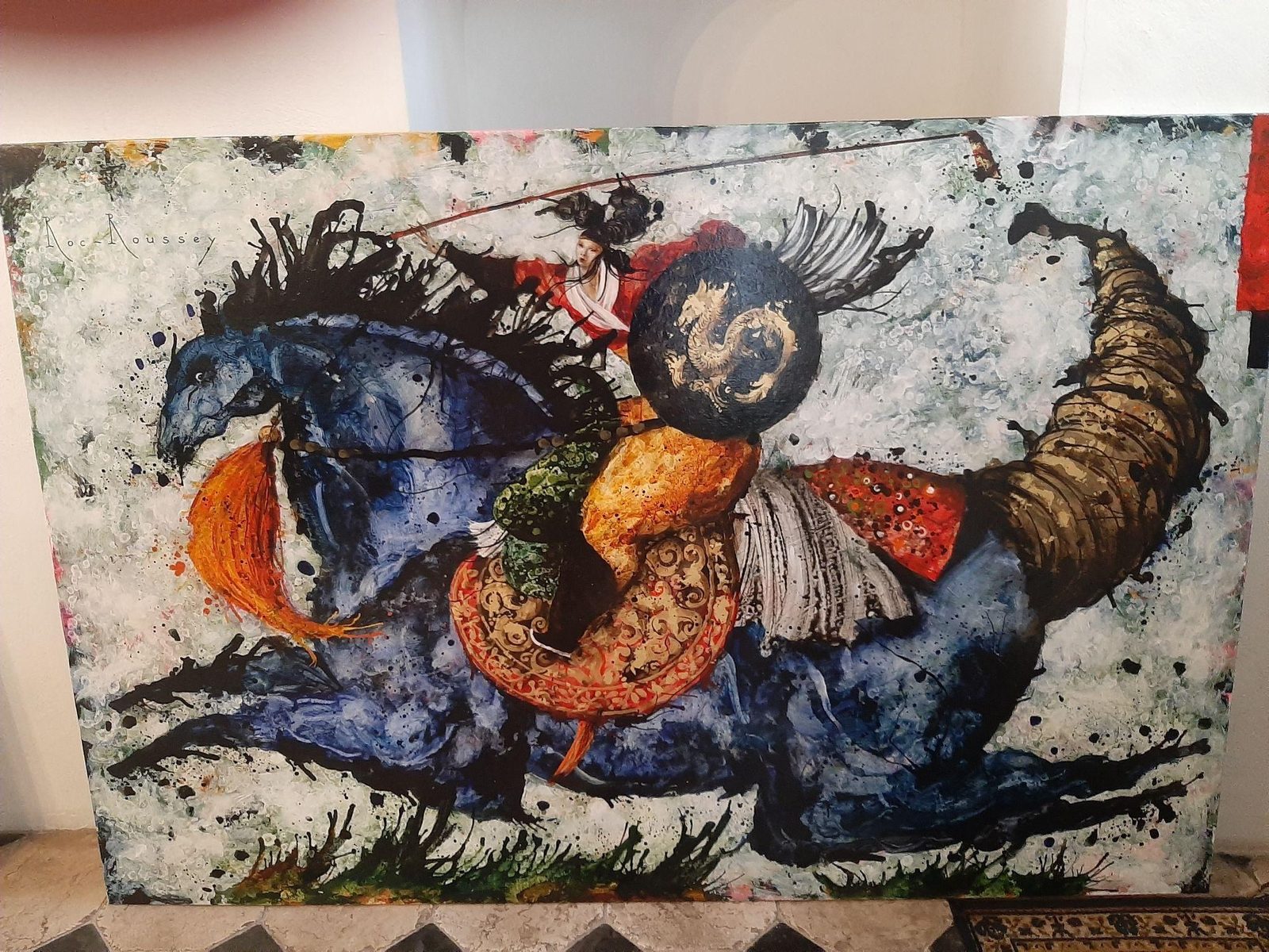 Close view of the painting sourced from France for the Caesarea estate: a rider with a spear on a blue horse, a gold shield, layered pigments and gold detailing on a pale ground