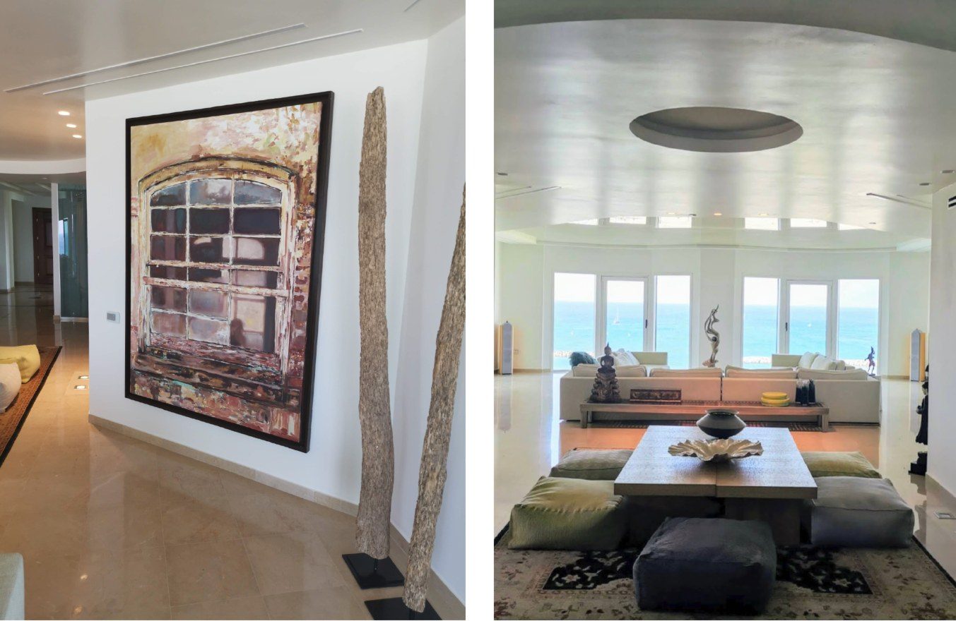 Two views of the Herzliya Pituach apartment: a large scale Yigal Ozeri painting of an aged arched window near the entrance, two tall driftwood sculptures beside it, and the living room opening to the sea
